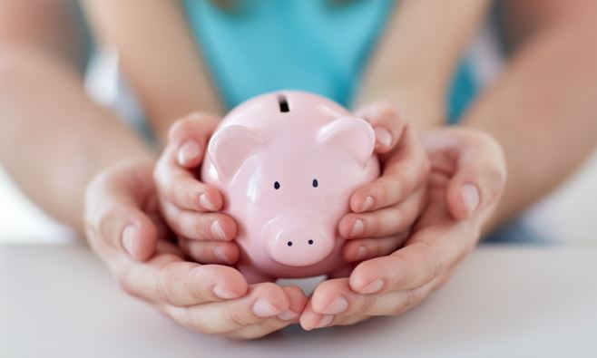 Hands Holding a Piggy Bank